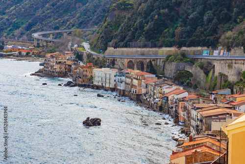 Italy, Calabria, Scilla. Houses built on rock right above the sea, with a highway above.