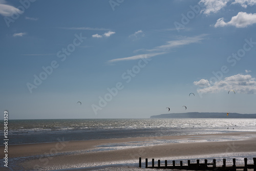 windsurfers on the beach and sea