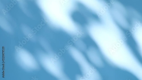 Abstract silhouette shadows of natural leaves tree branch falling on a light blue wall background. Transparent blurry shadow in morning sunlight with copy space for text,4K