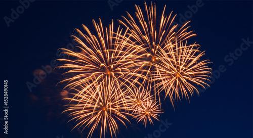  Golden sparkling fireworks in night sky creating dazzling bursts, symbolizing celebration and national pride