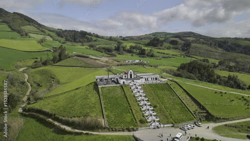 Drone orbits to the left in wide shot from front of Santuario de Nossa Senhora da Paz to the back in Vila Franca do Campo, Sao Miguel, Azores, Portugal