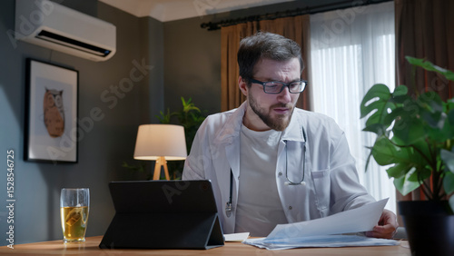 Doctor reviewing medical documents at home office