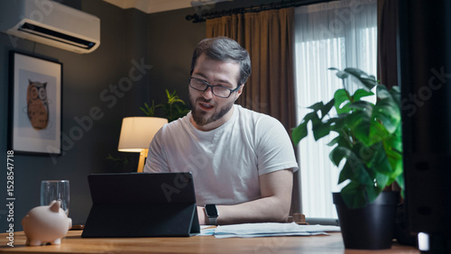 Man smiling during video call on laptop