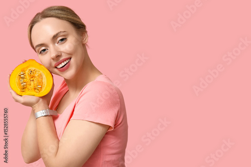 Young woman with pumpkin on...