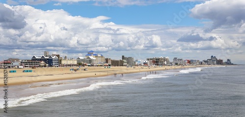 The panoramic view of the coastal architecture meets the ocean, creating a vibrant seaside scene with crowds on the beach on a sunny day near Ocean City, Maryland, U.S.A