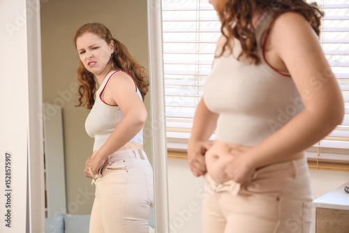 Upset young woman in tight ...