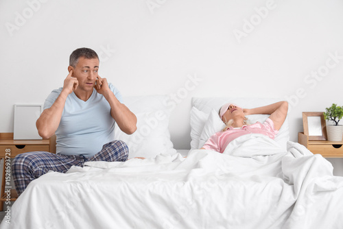 Irritated mature man coveri...