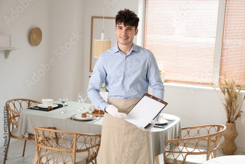 Young waiter with clipboard...