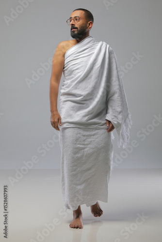 
Muslim man wearing Ihram clothing during Hajj or Umrah, captured in various poses—walking, praying, drinking water, and reading. Studio concept illustrating Islamic pilgrimage rituals.