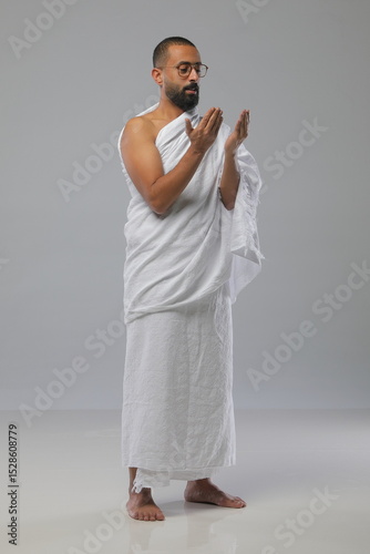 
Muslim man wearing Ihram clothing during Hajj or Umrah, captured in various poses—walking, praying, drinking water, and reading. Studio concept illustrating Islamic pilgrimage rituals.