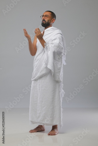 
Muslim man wearing Ihram clothing during Hajj or Umrah, captured in various poses—walking, praying, drinking water, and reading. Studio concept illustrating Islamic pilgrimage rituals.