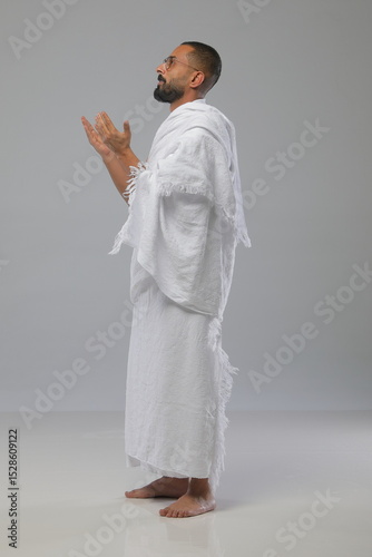 
Muslim man wearing Ihram clothing during Hajj or Umrah, captured in various poses—walking, praying, drinking water, and reading. Studio concept illustrating Islamic pilgrimage rituals.