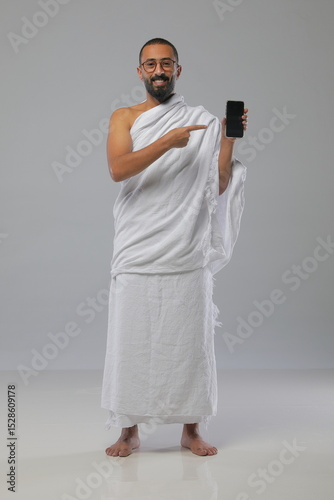 
Muslim man wearing Ihram clothing during Hajj or Umrah, captured in various poses—walking, praying, drinking water, and reading. Studio concept illustrating Islamic pilgrimage rituals.