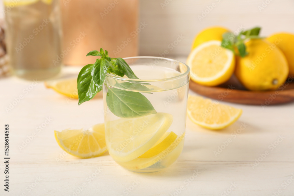 Fototapeta premium Glass of tasty lemonade on white wooden table, closeup