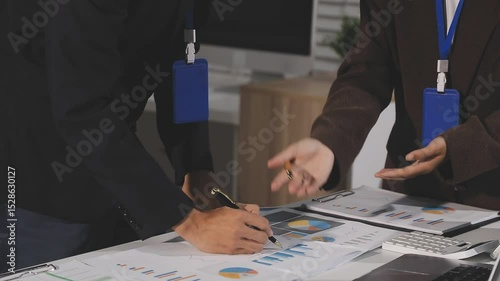 Millennial Asia businessmen and businesswomen meeting brainstorming ideas about new paperwork project colleagues working together planning success strategy enjoy teamwork in small modern night office.