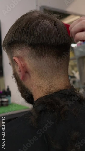 Barbershop. Unrecognizable male barber hands making customer Fashionable haircut in Modern style barber shop. Bearded Man client visit gentleman grooming beauty salon for hairstyle care