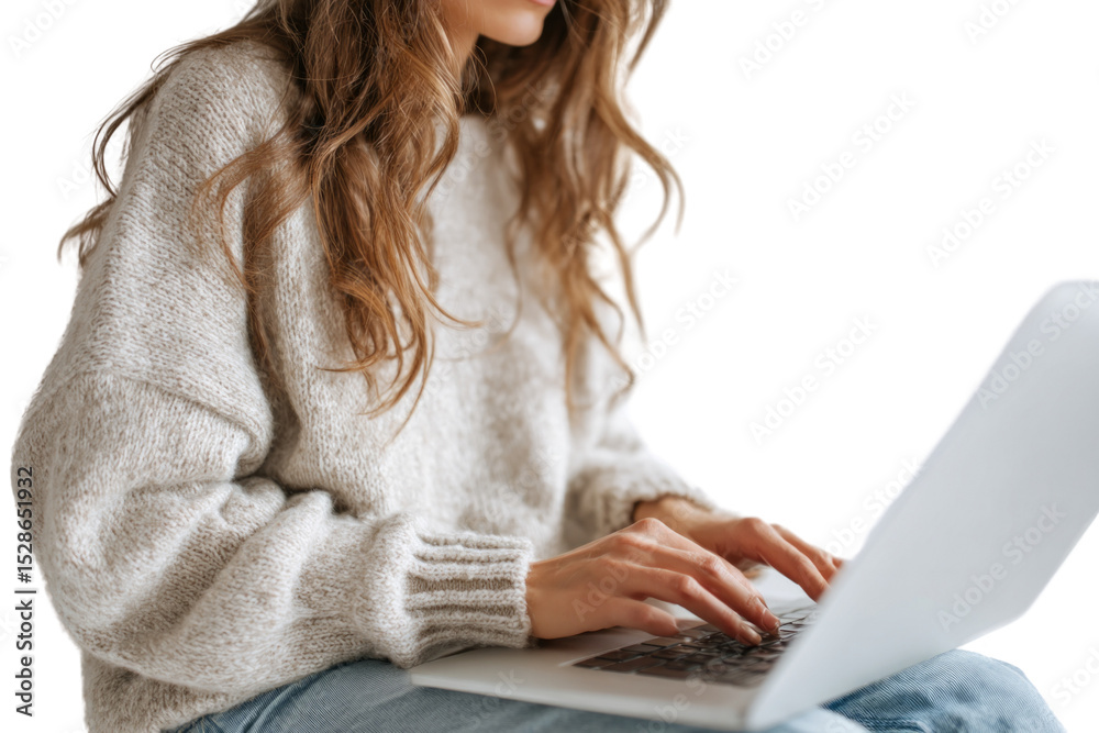 Naklejka premium A woman is sitting on a chair and typing on a laptop