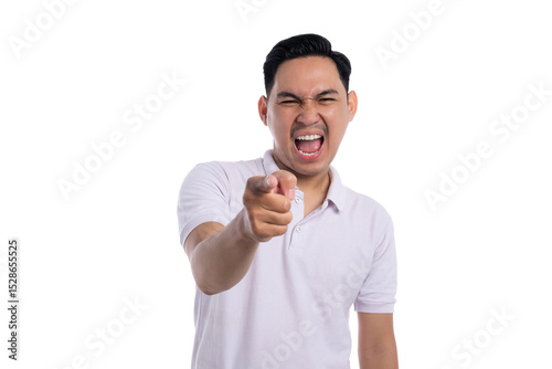 Angry young man shouting and pointing finger at camera with furious expression isolated on transparent background