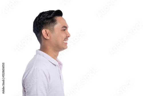 Wall Mural Side profile of smiling young man looking forward with positive expression isola
