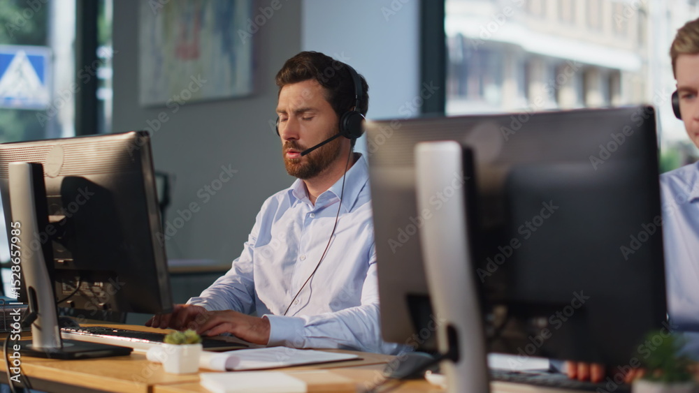 Obraz premium Contact center team working at computers talking headset in office space closeup