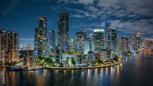 Experience the breathtaking and vibrant nightlife of Downtown Miami and Brickell Key through this stunning aerial hyperlapse. Witness the city lights beautifully reflecting on the water surface