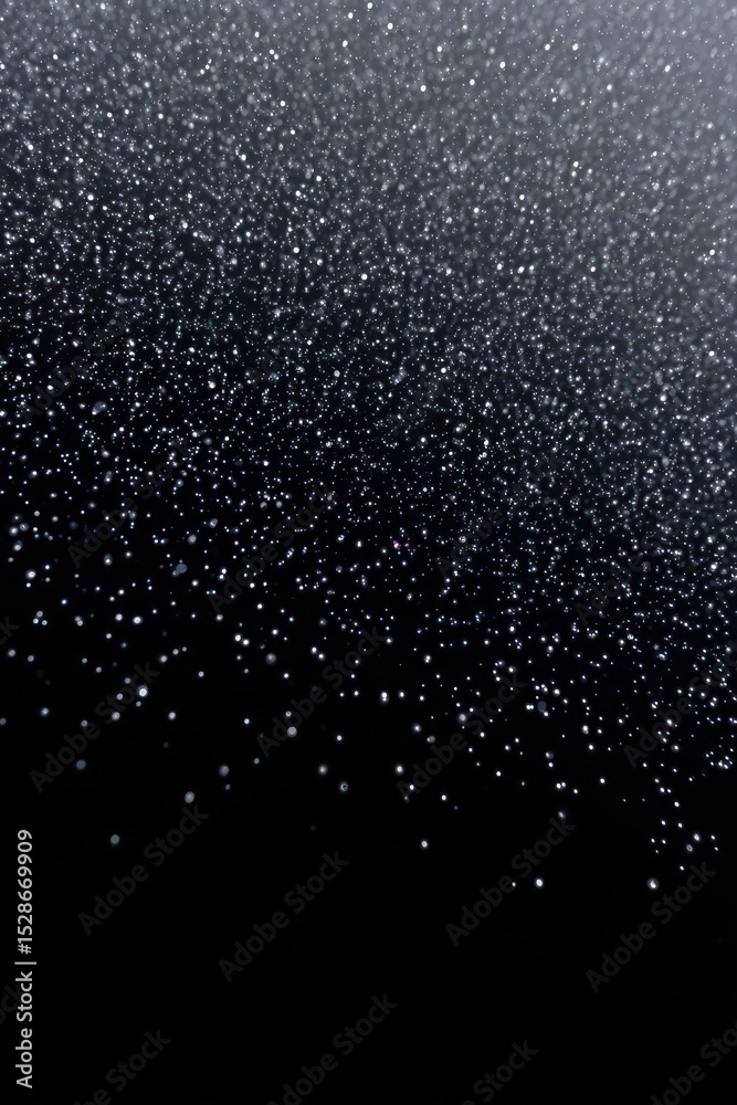 Obraz premium Abstract glittering particles falling on a dark background