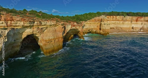 Aerial view of Benagil Cave, viewed through the circular cliff-top hole Algarve, Portugal