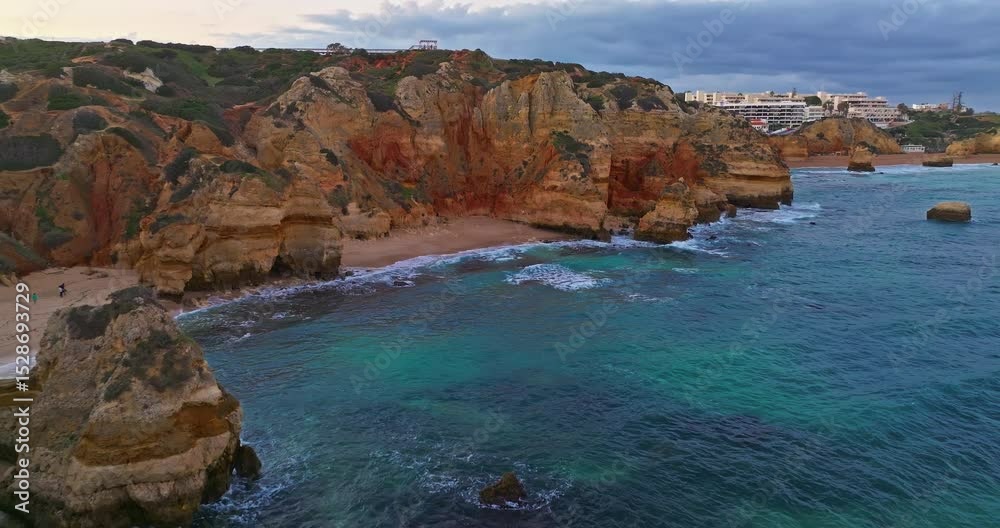 Aerial view of the point dramatic cliffs and lighthouse of Ponta da Piedade at sunset, Lagos, Portugal