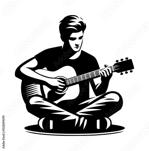 Young man playing acoustic guitar sitting cross legged