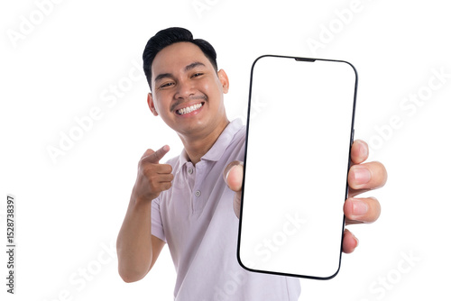 Cheerful young man pointing at blank smartphone screen and smiling isolated on transparent background