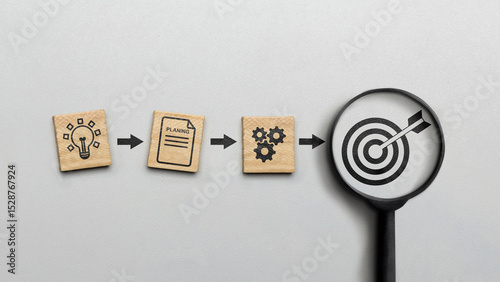Magnifying glass showing a dart and an arrow icon on a white background. Concept of the action plan