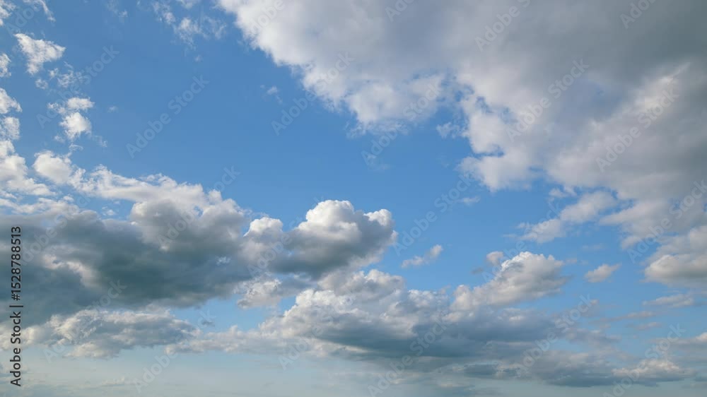 A stunningly beautiful blue sky adorned with fluffy white clouds floating peacefully above