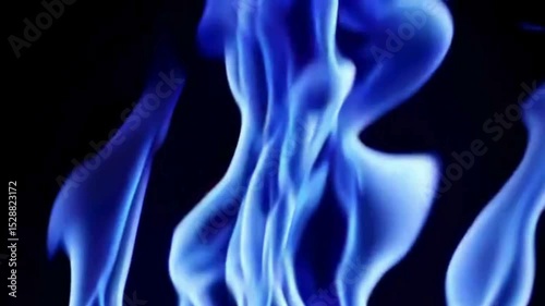 A mesmerizing swirl of electric-blue fire twists upward, its luminous tendrils flickering with motion, heat, and otherworldly grace in darkness