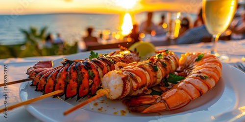 Fototapeta Naklejka Na Ścianę i Meble -  Grilled lobster and shrimp enjoying a seaside sunset dinner