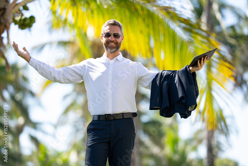 Hot business. Summer business. Business man on summer palm street. Businessman in summer. Mature stylish freelancer outdoors portrait. Handsome business man in casual wear on vacation.