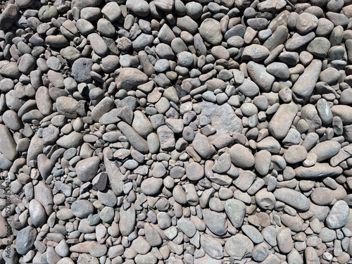 Grey darker pebbles stone for background., backdrop