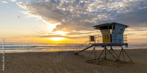 Konstfotografi Sun setting over the Pacific Ocean from public lifeguard tower 13 at Mission Bea