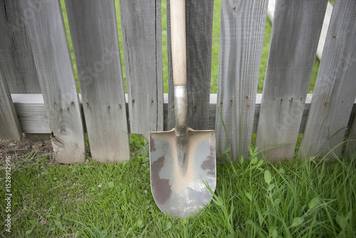 Shovel near a wooden fence outdoor scene