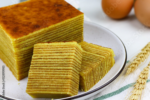 Lapis Legit or Spekkoek, One of Indonesian traditional layered cake. Lapis legit especially served during celebration or special day. White marble background.