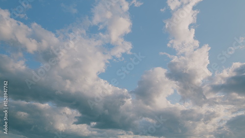 A Beautiful and Serene Cloudscape Set Against a Bright and Clear Blue Sky, Perfectly Calm