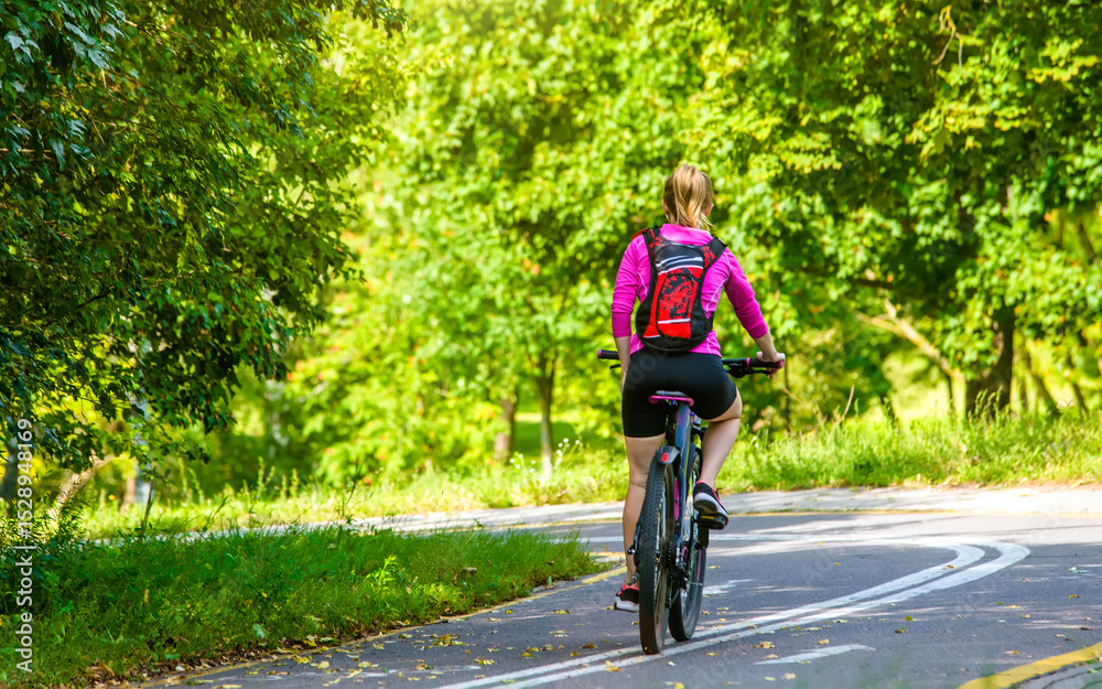 Fototapeta premium Cyclist ride on the bike path in the city Park 