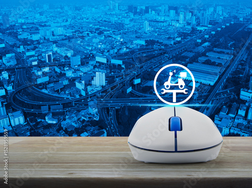 Service fix motorcycle with wrench tool icon on wireless computer mouse on wooden table over city tower, street, expressway and skyscraper, Business repair motorcycle online service concept