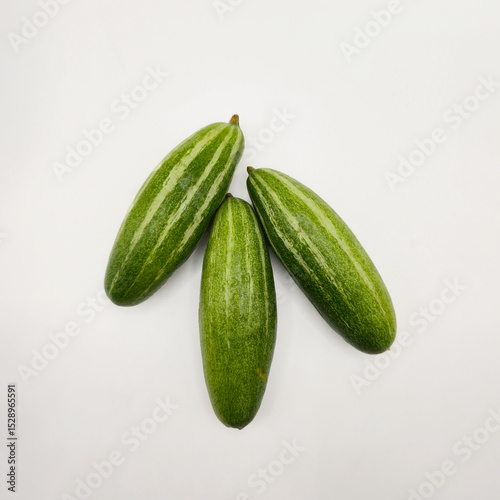 Potol or pointed gourd vegetable on isolated white background. Pointed gourds over white background. Green vegetable. High resolution image.