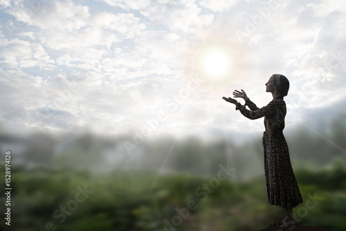 Young girl praying to God photo