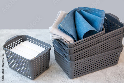 Plastic baskets for storing various things. Organization of home space, house order.