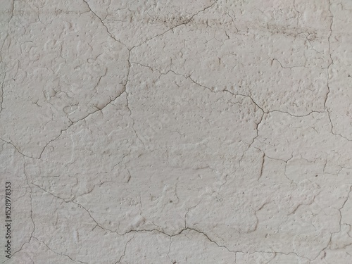 Aged white plaster wall with fine cracks great for architectural textures, retro-style designs, and aged wall surfaces