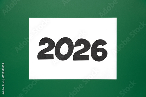 White sheet with the inscription 2026 on a green background