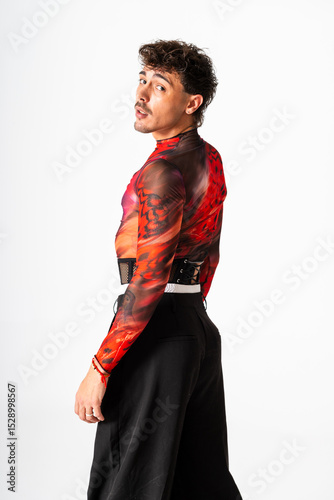 Portrait of a Young Gay Man Expressing Pride in Vibrant Attire on a White Backdrop