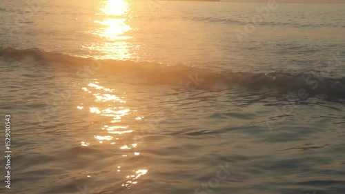 Morning sea waves, sunlight shining on the water.