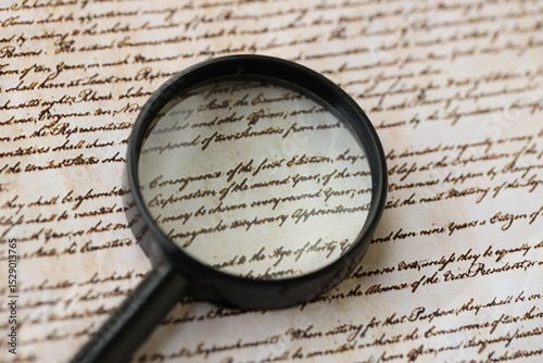 American USA Constitution paper page and magnifying glass close up